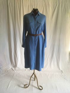 "vintage 1970s shirt dress LL Bean pure silk, slight nubby w/white undertones to weave button up long sleeve smoky blue collared w/point stays breast pocket w/button flaps side pockets about mid calf length, depending on wearer's height good vintage condition, light wear-see photos, light fade,slub, nothing major belt not included labeled size 14, see below measures, lying flat, shoulder-16\" chest-21\" waist-20 1/2\" hip-22\" sleeve-22 1/2\" length from top shoulder-46\"" Fitted Long Sleeve Shirt Dress For Work, Classic Shirt Dress With Spread Collar For Spring, Classic Shirt Dress With Pockets For Spring, Classic Spread Collar Shirt Dress For Fall, Classic Shirt Dress With Spread Collar For Fall, Classic Collared Shirt Dress For Spring, Fall Button-up Shirt Dress With Placket, Spring Cotton Shirt Dress With Spread Collar, Relaxed Fit Shirt Dress For Spring Workwear