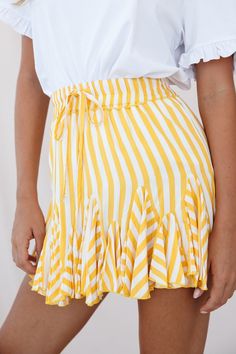 Twirl the day away in this adorable skirt featuring an elasticated waist with drawstring, prettiest stripe print fabric and flounce-frill inserts around the hem. Perfect for your Spring/Summer wardrobe. Pair it with a cool white tee or tank top. Dress it up with some tan wedges or go casual with some crisp white sneakers for a look we are loving.