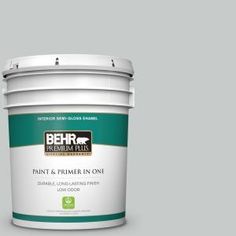 the behr paint and primer in one is shown on a dark brown background