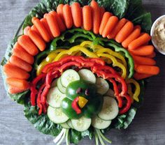 a platter with carrots, cucumbers and other veggies