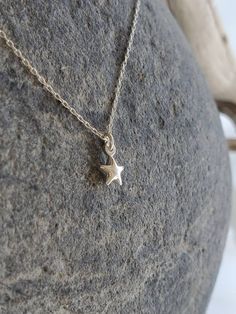 "Beautiful. Delicate Tiny Sterling Silver 6mm (0.23 inches) star charm hangs delicately from a Sterling Silver chain. It has a slightly puffed shape. Made from aold sterling silver, it is a great every day necklace. Shown in 17\" length. Please message me if you would like more than the quantity listed. I can produce custom orders of any quantity within a week. Visit my shop: http://www.etsy.com/shop/Jadedslo All items are individually hand assembled and I guarantee the workmanship and quality o Dainty Star Charm Necklaces, Dainty Star-shaped Necklace With Starfish Charm, Dainty Star-shaped Charm Necklace, Dainty Star Charm Necklace, Minimalist Star Charm Pendant Necklace, Delicate Star Charm Necklace For Gift, Tiny Star Shaped Minimalist Necklaces, Tiny Star Minimalist Necklaces, Minimalist Tiny Star Necklaces