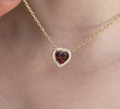 HEART GARNET & DIAMOND HALO NECKLACEA romantic, elegant and sophisticated way of celebrating your anniversary or lover's birthday. This beautiful necklace displays a heart shaped Garnet surrounded by Diamonds. With a feminine and refined finish, this piece of jewellery is sure to exalt your lover's beauty as it rests on her neck.DETAILSMain Stone  Stone: Garnet  Shape: Heart  Color: Red  Measurements: 10mm Side Stones Round Diamonds: 1.25mm (28)Band  Style: Chain  Material:  14k Gold: yellow, wh Garnet Heart Necklace, Red Garnet Necklace, Diamond Necklace Gift, Necklace Displays, Pinterest Jewelry, Diamond Heart Necklace, Garnet Heart, Anniversary Necklace, Heart Necklaces