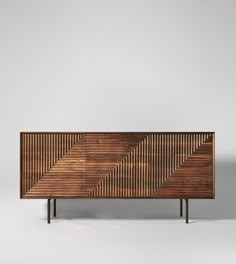 the sideboard is made out of wood and has an interesting geometric pattern on it