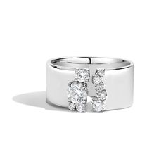 a white gold ring with two diamonds on the top and one diamond in the middle