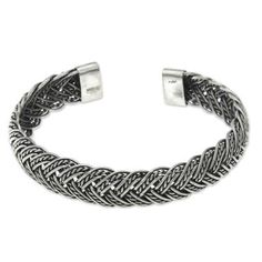 Sterling strands intertwine in a delightful silver bracelet. Braided by hand this cuff from Komang Wijayana is a modern classic. .925 Sterling silver Adjustable White Gold Bangle With Sterling Silver Clasp, Sterling Silver Adjustable Bangle Bracelet, Classic Silver Adjustable Braided Bracelets, Adjustable Silver Chain Bracelet With Oxidized Finish, Silver Sterling Silver Braided Bangle Bracelet, Adjustable Oxidized Silver Chain Bracelet, Formal Adjustable Sterling Silver Bracelet With Oxidized Finish, Adjustable Braided Bangle Jewelry, Adjustable Silver Jubilee Bracelet Bangle