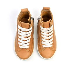 One of our top-selling leathers (and a piper finn favorite here at the office)! This perfectly natural tan sneaker is made of our most premium waxed leather yet! A leather so great, the more you wear it, the better it looks! High Top Sneaker Features:Premium top-grain leatherZip-up sides for an easy on/off designPerforated and cushioned insoles for comfortability and breathability.100% cotton laces Nonskid rubber soles Please review the Sizing Chart before purchasing. Tan Sneakers, Shoe Wardrobe, High Top Sneaker, Leather High Tops, Tailored Design, Natural Tan, Top Grain Leather, Toddler Shoes, Top Selling