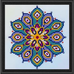 a cross - stitch pattern is shown in the shape of a flower with many colors