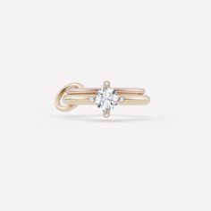 The Aine ring is the most delicate of our engagement styles. Featuring 18k rose and yellow gold bands and a compass set solitaire stone with bezel-set white diamond prongs. Given the delicate profile of the Aine silhouette, we advise setting a half carat to one carat center stone. Bands: 18k rose gold, 18k yellow gold 1.7mm gauge 18k rose gold band 2.3mm gauge 18k yellow gold band Connector: 18k yellow gold Compass setting, bezel-set diamond prongs *Pricing is based on a VVS clarity solitaire st 14k Gold Jewelry With Single Diamond For Proposal, 14k Gold Single Diamond Jewelry For Proposal, Minimalist Yellow Gold Diamond Ring For Proposal, Timeless Solitaire Stackable Rings, Timeless Rose Gold Stackable Rings With Single Diamond, Timeless Single Diamond Ring For Proposal, Timeless Rose Gold Solitaire Stackable Rings, Timeless Solitaire Stackable Rings In Rose Gold, Yellow Gold Rings With Single Diamond For Proposal