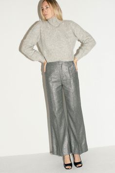 Shimmery trousers with a flared leg. Mid rise with a zip and hook and eye closure. Fabric is 60% recycled wool, 27% polyamide, 9% polyester, 4% other fibers. Ella is 6' tall, 36" bust, 27.5" waist, 38" hip, and is wearing a size S Grey Pants, Bottom Clothes, Handmade Design, Modern Woman, Mid Rise, Trousers, Sparkle, Wool, Pants