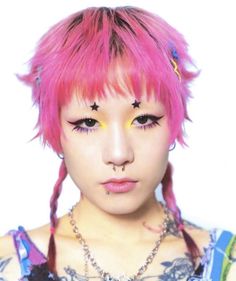 a woman with pink hair and piercings on her face