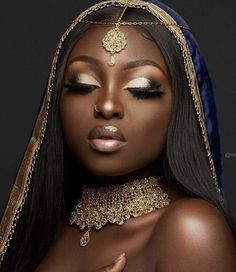 an african woman with long black hair and gold jewelry