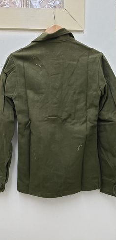 Vintage Military Issued Vietnam Era Wool ShirtSize-Extra SmallChest-up to 33 inches85% Wool 15% NylonDated-1976Condition-USED but looks NEW-see picsNSN# 8405-00-188-3794Made in the USA! check us out at www.armysurpluswarehouselexington.com Khaki Collared Winter Tops, Khaki Collared Tops For Winter, Green Military Style Work Tops, Green Military Style Workwear Top, Military Style Long Sleeve Tops For Fall, Green Military Style Tops For Work, Fitted Military Tops With Pockets, Military Style Green Winter Tops, Winter Military Collared Tops