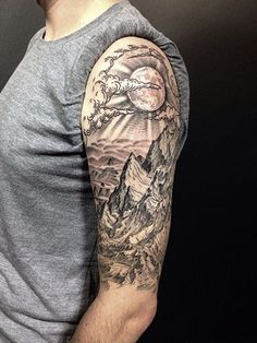 a man's arm with a mountain scene on it, and the words nature isn't it?