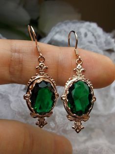 "Simulated Emerald Earrings Pin Design#E18 Custom Made These are Victorian reproduction estate earrings in rose gold plated sterling silver set with flawless A-quality simulated green emerald gemstones. Each stunning 6ct oval cut gem is 14mm long (9/16th\") and 10mm in width (3/8th\"). The earrings are 1 3/4th inches long. Notice the beautiful fleur de lis on the bottom and top of the setting. These lovely earrings were fashioned from an antique Victorian floral brooch. A gift box is included an Pin Design, Earrings Rose Gold, Floral Brooch, Emerald Earrings, Victorian Jewelry, Lovely Earrings, Green Emerald, Rose Earrings, Dream Jewelry