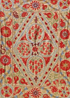 an intricately designed carpet with red and blue flowers