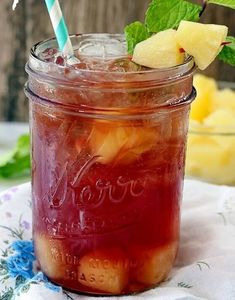 a mason jar filled with fruit and ice