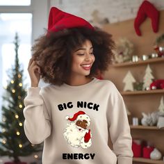 Black Santa Claus Big Nick Energy Christmas Sweatshirt, Celebrate the season with our charming Christmas sweatshirt featuring a lovable Black Santa Claus. This African American Christmas shirt is a perfect way to spread holiday joy and diversity while looking cute and festive. Tis the season to share the spirit of inclusion and merriment with this unique and heartwarming sweatshirt A sturdy and warm sweatshirt bound to keep you warm in the colder months. A pre-shrunk, classic fit sweater that's made with air-jet spun yarn for a soft feel and reduced pilling. * 50% cotton, 50% polyester * Pre-shrunk * Classic fit * 1x1 athletic rib knit collar with spandex * Air-jet spun yarn with a soft feel and reduced pilling * Double-needle stitched collar, shoulders, armholes, cuffs, and hem For Matchi Black Family Matching Holiday T-shirt, Black Christmas Graphic Tee, Black Christmas Streetwear T-shirt, Black Santa Shirt, Funny Black Christmas T-shirt, Black Santa, Christmas Tote Bags, Santa Shirts, Fitted Sweater