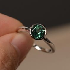 This is a gorgeous handmade creation. Its beauty is its simplicity & Elegance. The 7*7mm round cut lab green sapphire is crafted in solid sterling silver / 14k gold. It is available to customized, if you have any mind, just let me know, we will discuss with it. All item is sent in a beautiful gift box You can realize more lovely stuff clicking the link https://www.etsy.com/shop/knightjewelry?refshopsection_shophome_leftnav Please leave the correct address and you PHONE NUMBER for delivering Sterling Silver Jewelry With Tension Setting Round Cut, Classic Round Emerald Ring With Tension Setting, Formal Emerald Ring With Tension Setting For May Birthstone, Classic Emerald Ring With Round Stone For Anniversary, Green Sapphire Round Ring, Formal Round Cut Emerald Ring With Tension Setting, Sapphire Jewelry For May Birthstone, Fine Jewelry Emerald Solitaire Ring In Round Cut, Bezel-set May Birthstone Jewelry