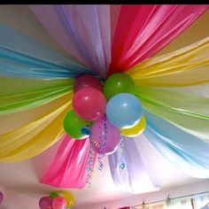 the ceiling is decorated with balloons and streamers