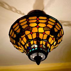 a stained glass lamp hanging from the ceiling