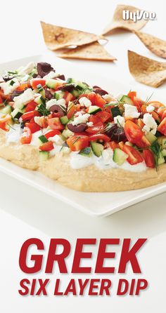 a close up of a pizza on a plate with the words greek six layer dip