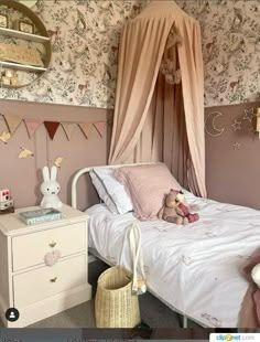 a bedroom with pink walls and floral wallpaper