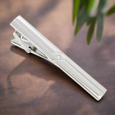 This chrome tie clip, adorned with intricate designs, adds a subtle yet sophisticated flair to any outfit. Its polished finish and detailed craftsmanship make it versatile and eye-catching. Dress Shirts: Solid Light Blue Dress Shirt - Provides a gentle contrast that highlights the intricate chrome details. White Dress Shirt with Fine Stripes - Adds a textured look while maintaining a classic style. Soft Pink Dress Shirt - Offers a stylish and modern touch that pairs well with the chrome finish. Luxury Silver Suit And Tie Accessories For Business, Silver Suit And Tie Accessories For Formal Occasions, Elegant Silver Suit And Tie Accessories For Gift, Silver Elegant Suit And Tie Accessories For Gift, Classic Silver Lapel Pin For Business, Luxury Silver Suit And Tie Accessories For Formal Occasions, Elegant Silver Suit And Tie Accessories For Formal Events, Modern Silver Suit And Tie Accessories For Business, Soft Pink Dress