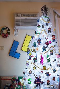 a white christmas tree with lots of stickers on it