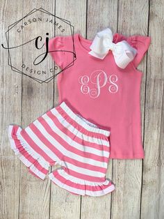 Check out this adorable monogram pink shirt and matching shorts! The perfect outfit for spring and summer!The shirt is an angel sleeve shirt in a beautiful bubble gum pink color. The pants are pink and white stripe with an elastic waist and ruffles around the bottom. We also have the outfit available in navy, peach, red, and navy! If interested in one of these colors please message us for availability!The shirt features a large monogram on the center of the chest that is embroidered directly ont Pink Short Sleeve Short Set For Summer, Cute Pink Short Set For Summer, Cute Pink Sets With Short Sleeves, Playful Pink Ruffled Shorts, Cute Short Sleeve Short Set For Spring, Cute Short Sleeve Set For Spring, Cute Pink Ruffled Shorts, Cute Pink Short Sets, Cute Pink Cotton Short Set