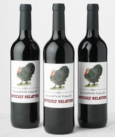 three bottles of red wine sitting next to each other