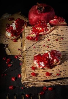 an old book with pomegranates on it