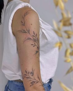 a woman's arm with a flower tattoo on the left side of her arm