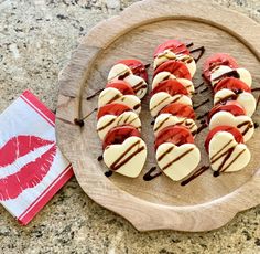 a wooden plate topped with heart shaped desserts