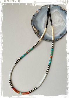 Native American heishi necklace by artist Mary Calabaza (white shell) 20" Beautiful necklace with nice combination of colors...white shell, blue turquoise, coral, melon shell and jet. By the talented Santo Domingo artist Mary Calabaza. Measurements : 20" long 4mm beads sterling silver closure copper ring/bead with artist signature