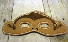 a brown mask sitting on top of a wooden floor