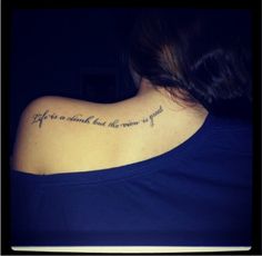 the back of a woman's neck with a tattoo saying life is short but the reason is good