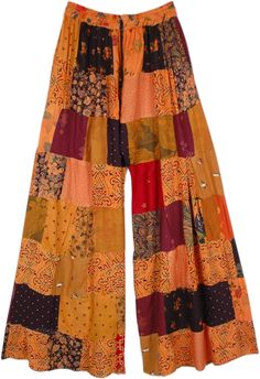 These 70s boho chic pants are all you need for the season! With their assorted patterned patchwork style, these pants are made of recycled fabric and so environment-friendly and absolutely unique.  A comfortable loose wide-leg style with an elastic drawstring waist, you can lounge around in them or even go traveling! Colorful patchworks are pieced together harmoniously and complement each other making the overall look very stylish. #tlb #SplitSkirtsPants #Patchwork #beachwrap #Fall #Floral #bohe Bohemian Wide Leg Bottoms With Patchwork, Hippie Wide Leg Patchwork Pants, Hippie Wide-leg Patchwork Pants, Festival Patchwork Wide Leg Bottoms, Wide Leg Patchwork Bottoms For Festival, Bohemian Cotton Bottoms With Floral Patchwork, Bohemian Multicolor Wide Leg Pants, Bohemian Cotton Pants With Floral Patchwork, Hippie Style Multicolor Wide Leg Pants