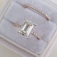 an engagement ring and wedding band set in white gold with a emerald cut diamond surrounded by pave diamonds