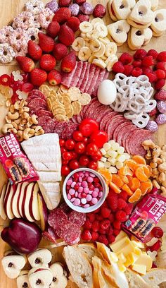 a table topped with lots of different types of food and snacks on top of it