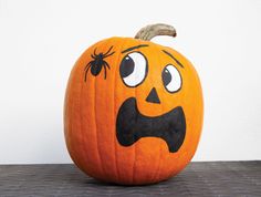 a pumpkin with a face drawn on it