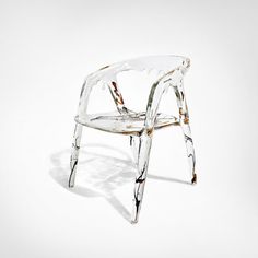 a clear plastic chair sitting on top of a white floor