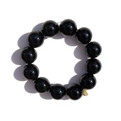 Onyx Bracelet by Marne Onyx, known for its deep black color and smooth, polished finish, is the highlight of this Marne bracelet. Featuring 12 bold onyx stones, this bracelet includes a 22K gold-plated Marne tag and an elastic fit, adding a sleek, refined touch to any look. Key Features: 12 Onyx gemstones, each 16mm/0.62 inch 22K Gold plated Marne tag Elastic fit for comfortable wear Bracelet length: 19.2cm/7.56 inch in total Gift Ideas and Occasions This onyx bracelet makes an elegant gift for Alphabet Jewelry, Unique Fashion Jewelry, Black Onyx Bracelet, Stocking Fillers For Her, Forever Jewelry, Onyx Bracelet, Onyx Gemstone, Jewelry Ring Box, Stone Gold