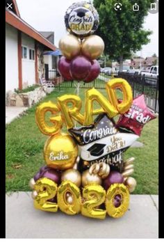 some balloons are stacked on top of each other in the shape of a graduation cake