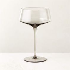 an empty wine glass sitting on top of a table