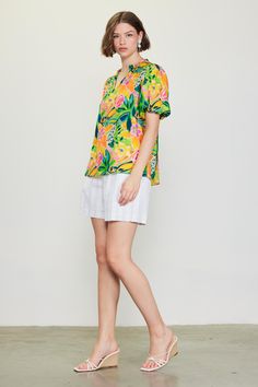 Do the bright thing in this statement-making top. With an artful floral print and bubble sleeves, it's a real mood booster. •Split neckline •Ruffle trim •Puffed short sleeves •Relaxed fit Item Number: 45552 Vibrant Green Floral Print Blouse, Summer Puff Sleeve Short Sleeve Top, Vibrant Short Sleeve Spring Blouse, Vibrant Short Sleeve Blouse For Spring, Casual Floral Print Short Sleeve Top For Summer, Spring Short Sleeve Blouse With Bold Print, Spring Short Sleeve Top For Day Out, Summer Blouse With Bold Print, Vibrant Yellow Floral Print Tops