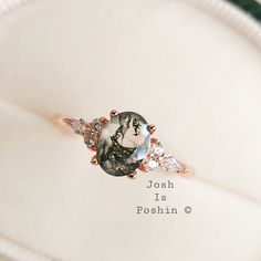 a ring with an image of a woman on it sitting on top of a white cloth