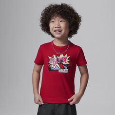 This tee is for the kid who loves comics and bball. It's made of soft cotton/poly jersey, has a tagless crewneck for a comfy feel and pairs well with any Jordan bottoms for a coordinated look. Red Cotton T-shirt For Fan Conventions, Sporty T-shirt With Cartoon Print For Sports, Casual T-shirt With Character Print For Sports, Red Graphic Print T-shirt For Fan Conventions, Playful Red Character Print T-shirt, Sporty T-shirt With Cartoon Print, Red Cotton T-shirt With Cartoon Print, Sporty Tops With Character Print For Fans, Red Cotton Pop Culture T-shirt