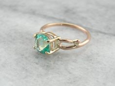 This is a beautiful vintage engagement ring, a solitaire that is as lovely as it is versatile! Simple sweeps of gold grace the shoulders, providing a perfect balance to the gorgeous center stone. We've set a Colombian emerald in this ring, a bright green gem with unbelievable shine! Incredibly clear and filled with light, this emerald is of exceptional quality, a one of a kind stone from our collection of Colombian gems that we're proud to offer! Metal: 14K Yellow and Rose Gold Gem: Emerald 1.56 Emerald Gold Engagement Ring, Beautiful Engagement Rings Vintage, Emerald Solitaire Ring, Columbian Emeralds, Beautiful Rings Vintage, Green Gem, Cushion Cut Ring, Colombian Emeralds, Jewelry Fashion Trends