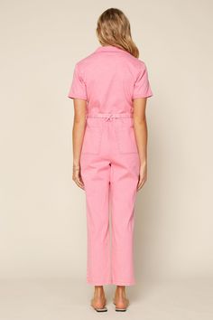 A playful spin on utilitarian style, this short-sleeve jumpsuit comes in a pink shade that's just so much fun to wear. It's a one-and-done outfit with a self-tie belt and pockets galore. Simply cuff up the ankles and add a fresh pair of sneakers. •Notched collar •Button placket •Short sleeves •Patch pockets •Optional s Spring Utility Denim Jumpsuit With Short Sleeves, Spring Short Sleeve Utility Denim Jumpsuit, Utility Denim Jumpsuit With Short Sleeve And Relaxed Fit, Relaxed Fit Denim Jumpsuit With Short Sleeves And Pockets, Utility Style Denim Jumpsuit With Relaxed Fit, Utility Short Sleeve Denim Jumpsuit With Pockets, Utility Denim Jumpsuit With Pockets And Short Sleeves, Utility Denim Jumpsuit With Short Sleeves And Pockets, Cotton Short Sleeve Jumpsuits And Rompers With Button Closure