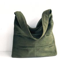 Please check 'shop announcement' for production time and delivery before your purchase.  This gorgeous bag is made from forest green pure hemp material. I really love its unique texture and the ruggedness of hemp, giving you a different feeling from other kinds of fabric. This everyday bag is sturdy and roomy enough to hold your essentials, such as books, wallet, Ipad, mobile and keys. It's fully lined with canvas, there are 2 slip pockets, one zipper pocket  and a pen slip inside. The strap has been interfaced with poly-fleece for your extra comfort.  A zipper closure keeps all of your items secure. If you prefer this bag to be with a magnetic snap please let me know. You can select the colors from the option menu in this listing. I make each bag individually by hand with lots of care, so Green Canvas Bag With Pockets For Daily Use, Casual Ethically Sourced Shoulder Bag For Everyday Use, Casual Everyday Bags Ethically Sourced, Dark Green Bag With Adjustable Strap For Daily Use, Casual Dark Green Bag For Daily Use, Eco-friendly Square Shoulder Bag For Everyday, Eco-friendly Green Shoulder Bag With Pockets, Eco-friendly Hobo Bag For Everyday, Green Canvas Tote Bag For Everyday